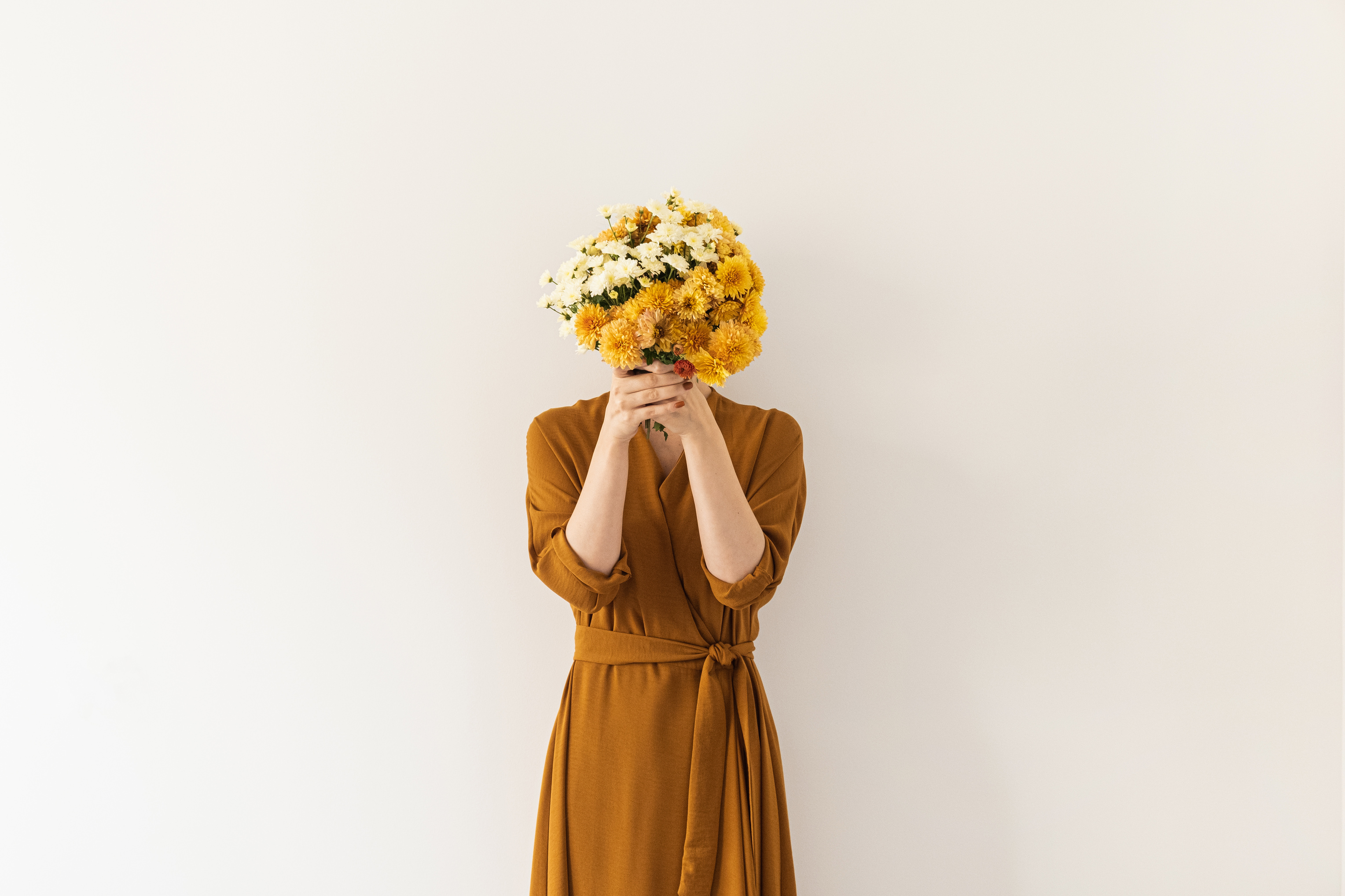 Portrait of Woman Covering Her Face with Bouquet of Flowers